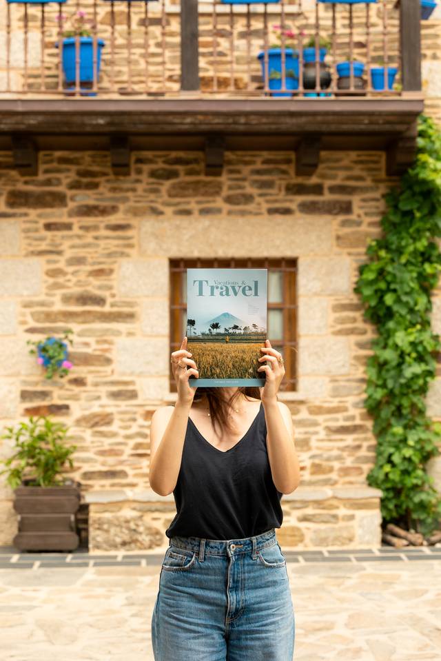 Foto revista de viagens segurada ao ar livre